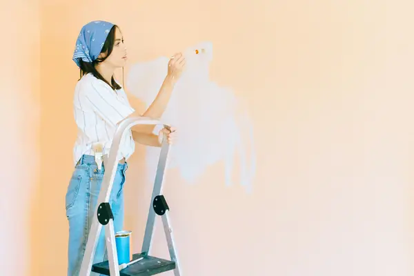 Interior painting in Chattanooga: painter on a stepladder rolling a wall
